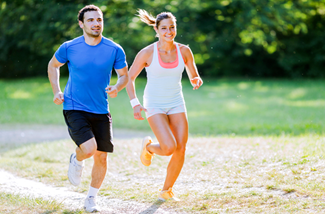 man and woman running together outside